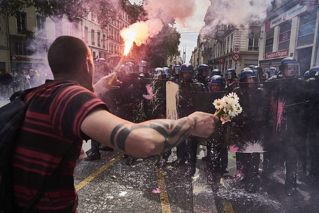 may-26-protester-lyon-france-held-flowers-torch-while-demonstrating-against-government-labour-reforms