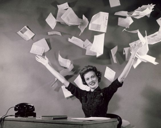 Businesswoman throwing papers in office --- Image by © SuperStock/Corbis