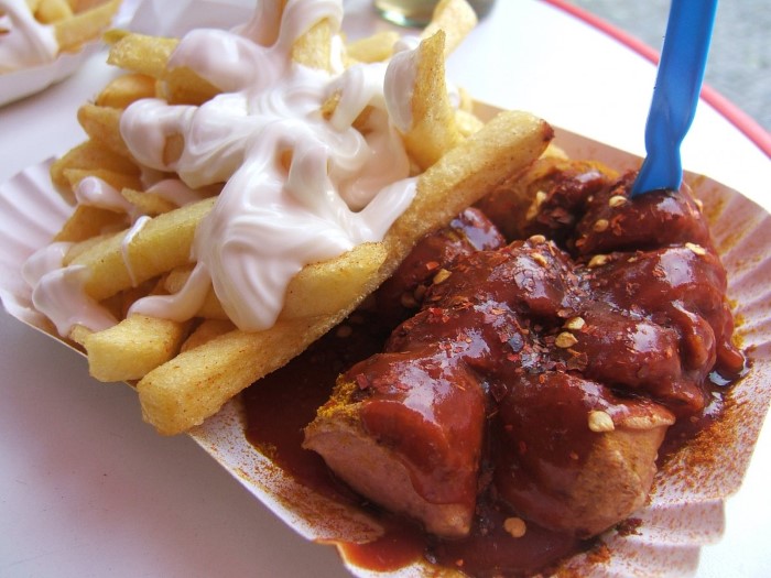 sample-berlins-iconic-street-food-currywurst-which-is-a-pork-sausage-thats-cut-into-slices-and-doused-with-curry-ketchup-berliners-love-konnopke-imbiss-located-in-the-prenzlauer-berg-neighborhood-cus
