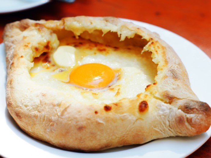 while-walking-the-streets-of-georgia-snack-on-khachapuri-a-savory-and-chewy-bread-filled-with-bubbling-cheese-or-egg-custom